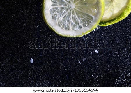 Water drops on ripe sweet lemon. Fresh lime  background with copy space for your text. Vegan and vegetarian concept.