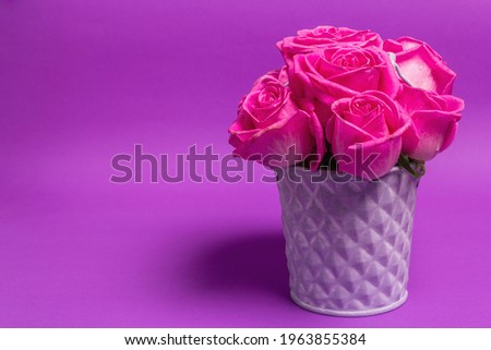 Bouquet of fresh pink roses in a bucket. The festive concept for Weddings, Birthdays, March 8th, Mother\'s, or Valentine\'s Day. Greeting card, lilac background