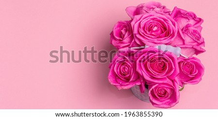 Bouquet of fresh pink roses in a bucket. The festive concept for Weddings, Birthdays, March 8th, Mother\'s, or Valentine\'s Day. Greeting card, light pink background, Banner