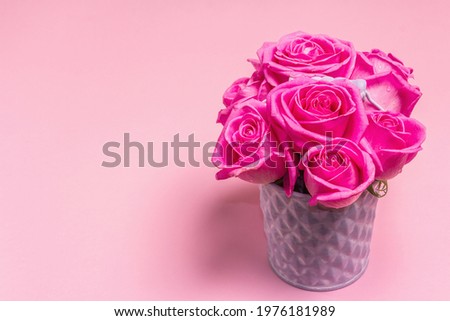 Bouquet of fresh pink roses in a bucket. The festive concept for Weddings, Birthdays, March 8th, Mother\'s, or Valentine\'s Day. Greeting card, light pink background