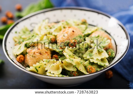 Farfalle pasta with meatballs and spinach  sauce with fried chickpeas. Proper nutrition. Sports nutrition. Dietary menu