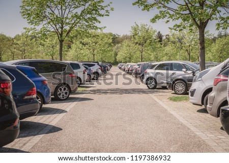row of cars in car parking lot, outdoor parking