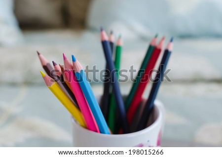 group of color pencils on bed