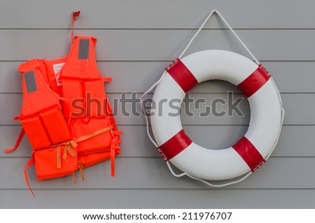 life vest and life belt on wooden wall