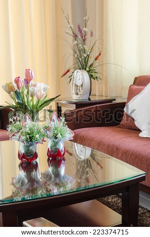 glass vase of flower on glass table in living room