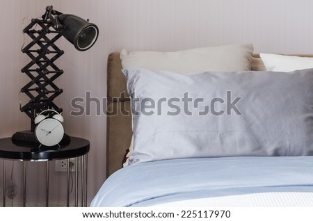 modern bedroom with modern lamp and alarm clock at home