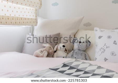 kid room with dolls and pillows on bed at home