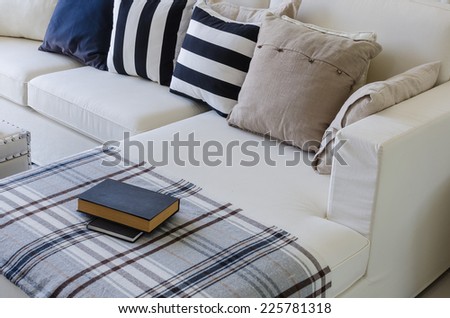 large white sofa with pillows and book in living room at home