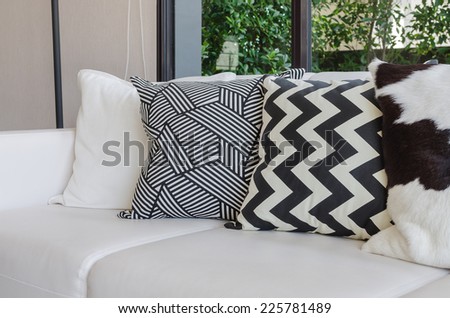 black and white pillows on white sofa in living room