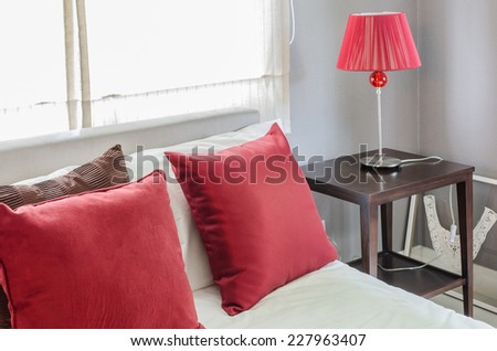 bedroom with red pillow and red lamp at home