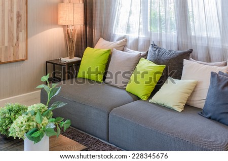 grey sofa and green pillows in living room at home