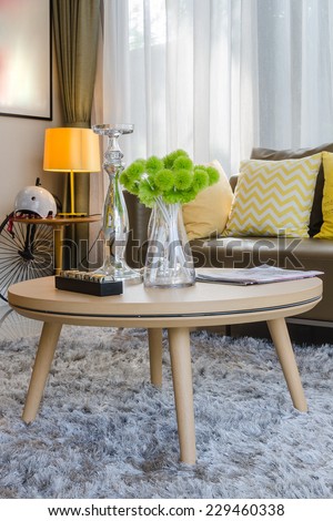wooden round table on carpet in modern living room