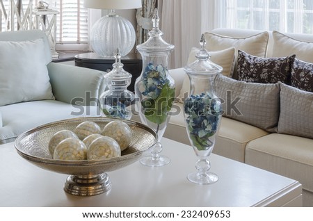 luxury earth tone living room with green leave in glass vase at home