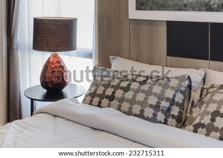 brown lamp on wooden round table in bedroom at home