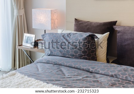modern bedroom with modern lamp on table at home