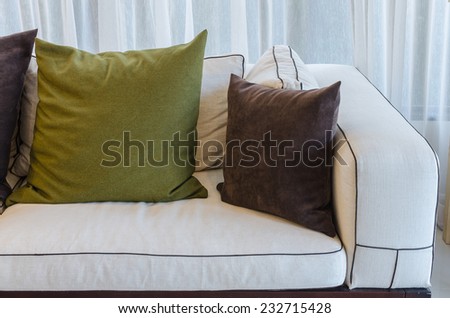 green pillow on white sofa in living room at home