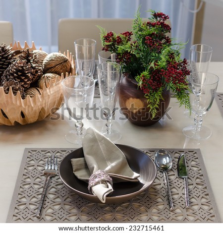 earth tone table set with flower in dinning room at home
