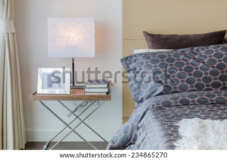 modern bedroom with modern lamp on table at home