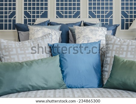 blue and green pillow on bed in luxury bedroom at home