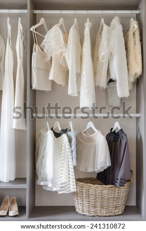 row of white dress with shoes in wardrobe at home