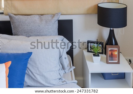 modern black lamp on white table in modern bedroom at home