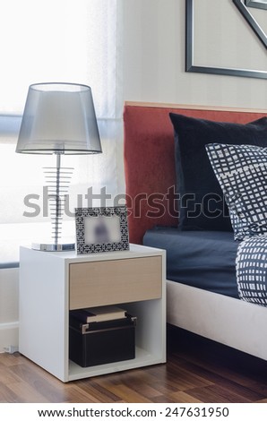 modern lamp on white table in modern bedroom at home