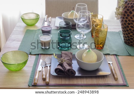 table set on wooden table in dinning room at home