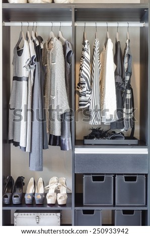 black and white clothes in black closet at home