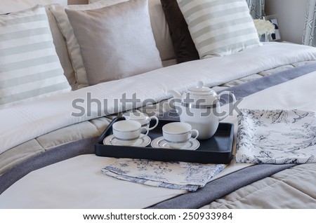 tea cup set on black tray in bedroom at home