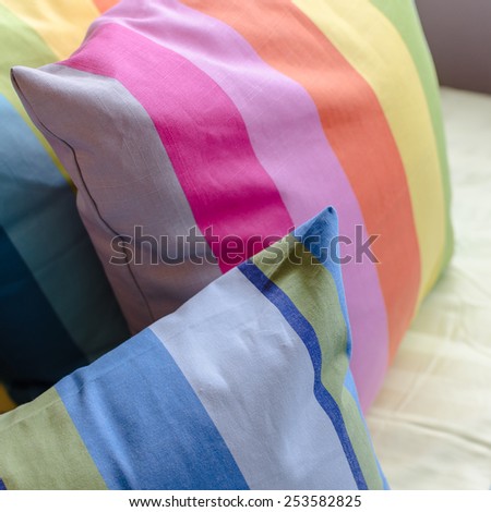 colorful pillows on bed in modern bedroom at home
