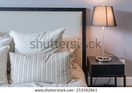 pillows on white bed with luxury lamp on wooden table at home