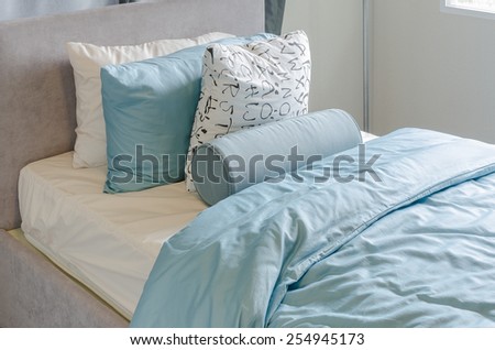 single bed in kid\'s bedroom with blue blanket at home