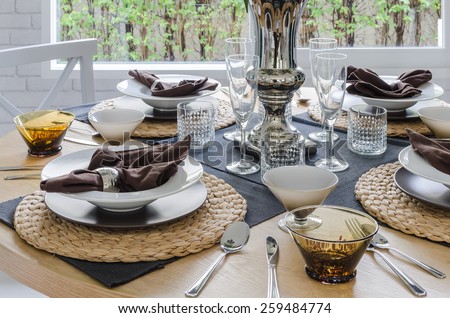 table set on wooden round table in dining room at home