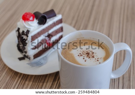 coffee with cake on wooden table in coffee shop