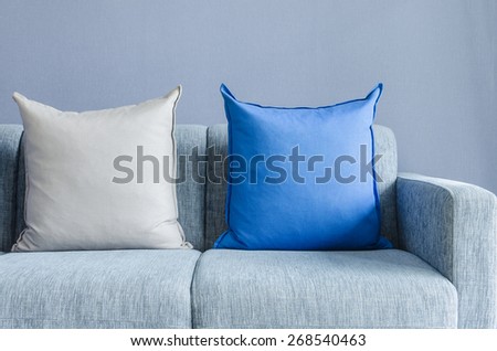 modern green sofa with blue and grey pillows in living room