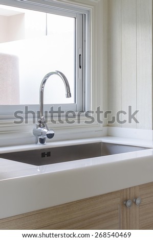 sink and faucet on white counter in kitchen room at home