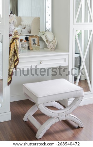 luxury dressing chair with female's accessories on table at home