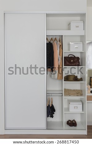 white closet with clothes and accessories at home