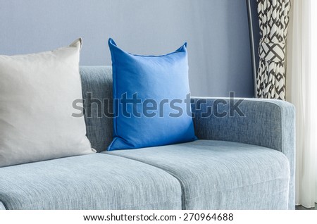 modern green sofa with blue and grey pillows in living room