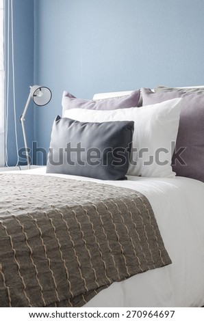 modern black lamp on white table in modern bedroom with blue wall