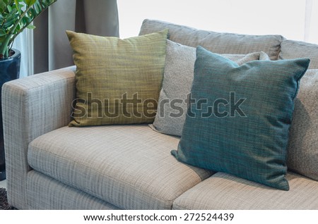 group of fabric pillows on fabric sofa in living room at home