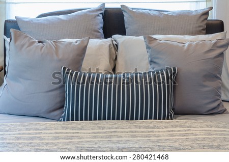 set of pillows on modern bed in bedroom at home