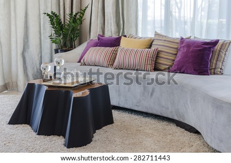 colorful pillows on modern sofa in living room at home