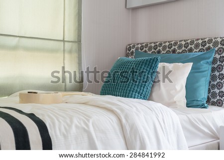 green pillows on modern bed at home
