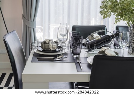 black and white modern dinning table with table set at home