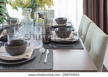 wooden dining table with table set at home