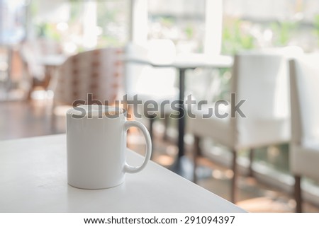 white coffee cup in coffee shop - vintage style effect picture