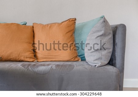orange color pillow on grey sofa in living room at home