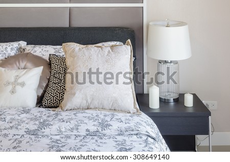 luxury bedroom with glass lamp on dark brown wooden table at home