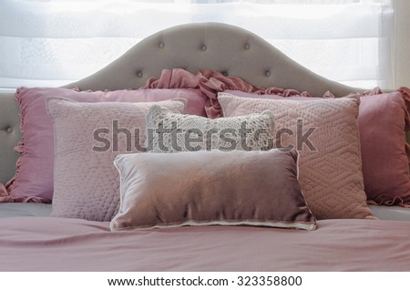 pink pillows on classic bed in girl\'s bedroom at home